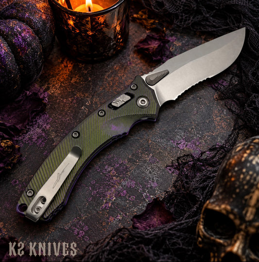 Microtech Marfione Select Amphibian Mini RAM-LOK Partial Serrated Nebula Green Fluted Titanium, SKU 137MRL-11FLMS17, editorial photo with candle and skull